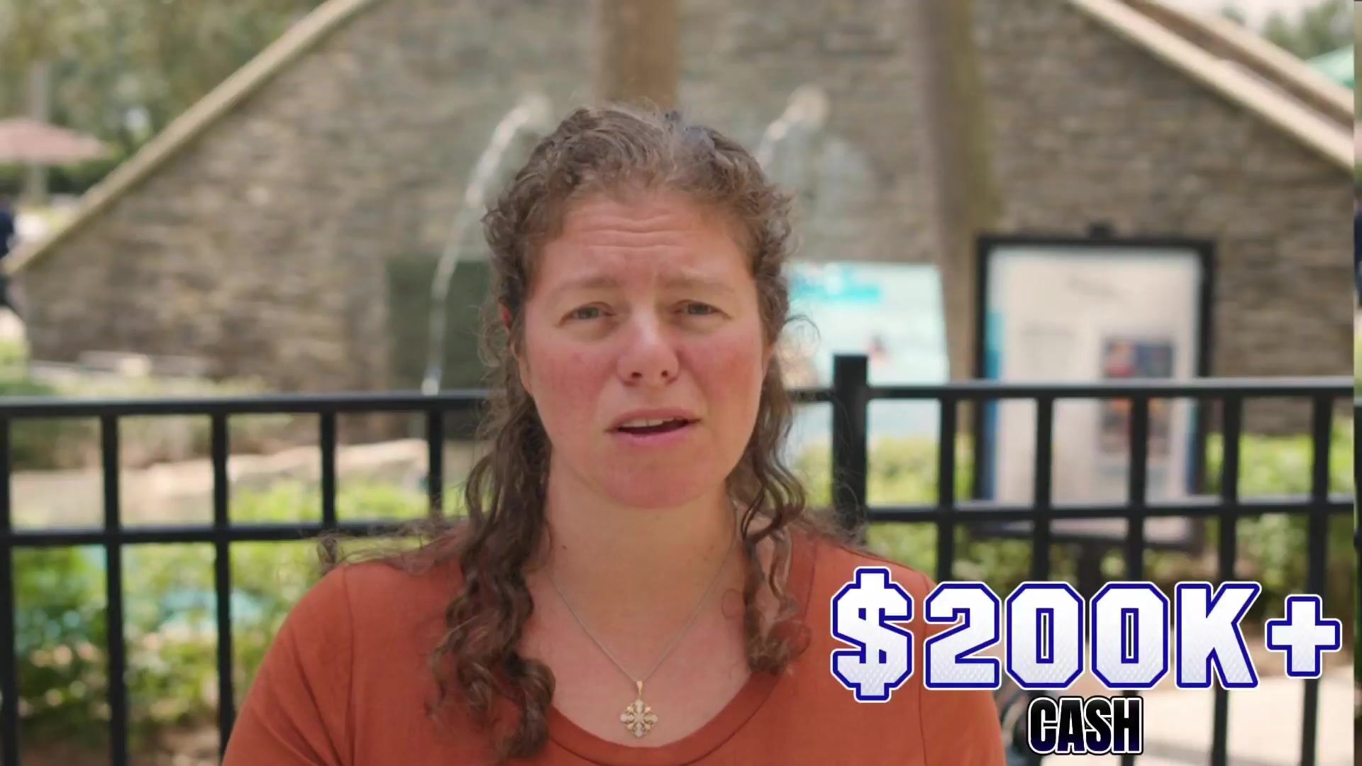 Dr. Emily Hill speaking outside a stone building